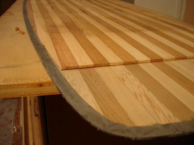 cut top core layer and fit to bottom, beveled sides with block plane, tapered thickness of both cores with router on a sled.