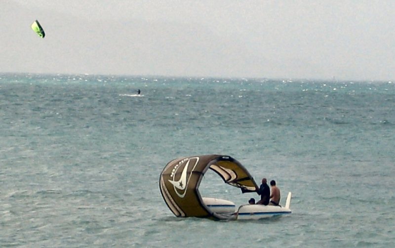 Word is these guys put in at Canoe beach and flipped the boat during a jibe when a gust hit them.  They finally made landfall just down-wind of action beach mast-less.