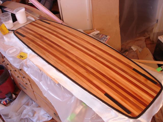 Since glass is light I added a 2.5mm filled epoxy layer under fins to avoid core damage. The epoxy goes all the way through the core in the fin screw area...