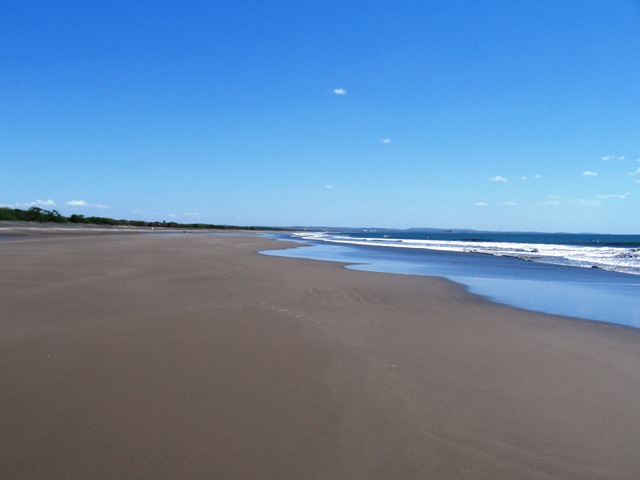 Salinas Grande beach. You can see white tanks in the background from Puerto Sandino.